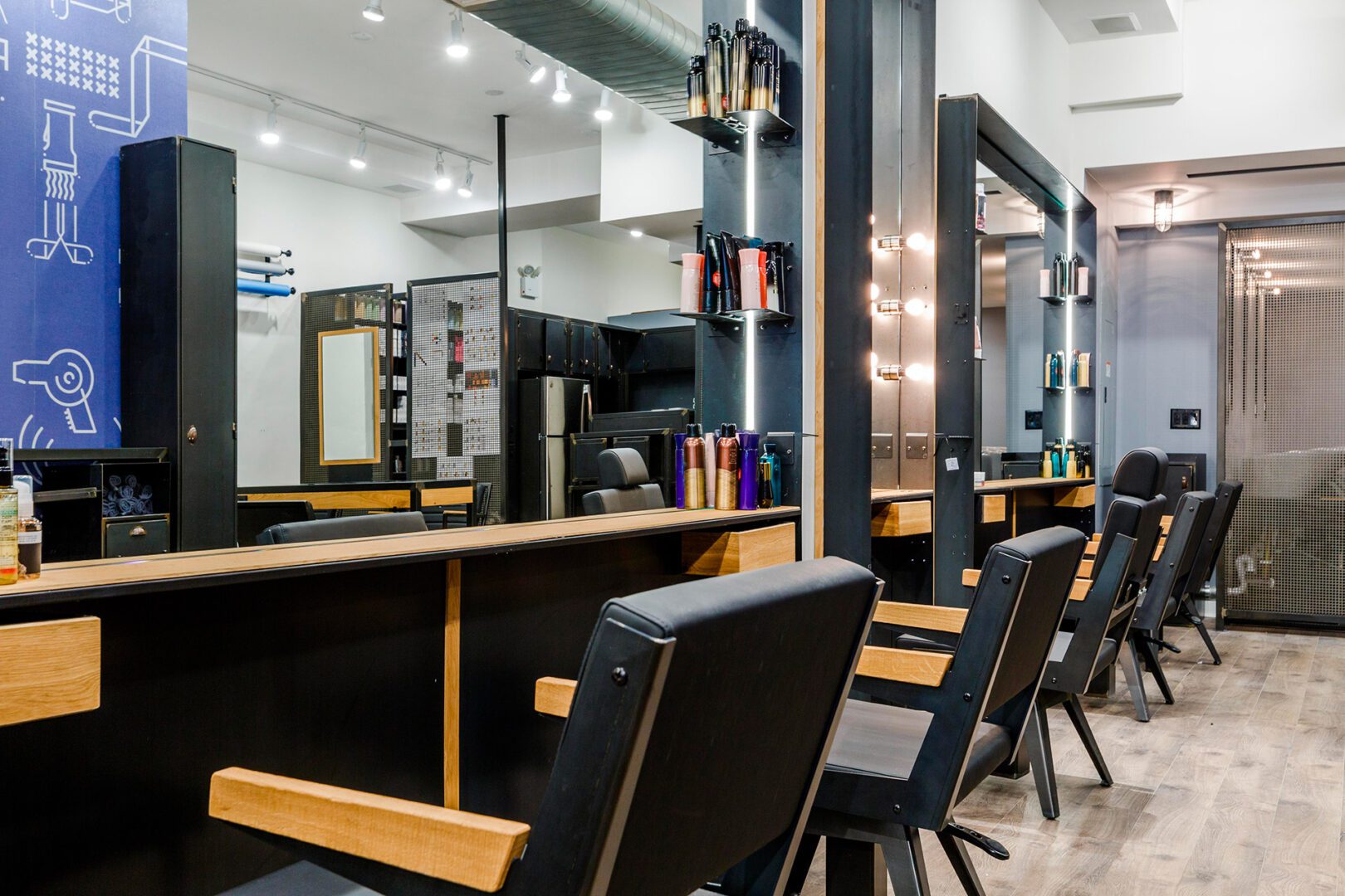 A hair salon with many chairs and mirrors